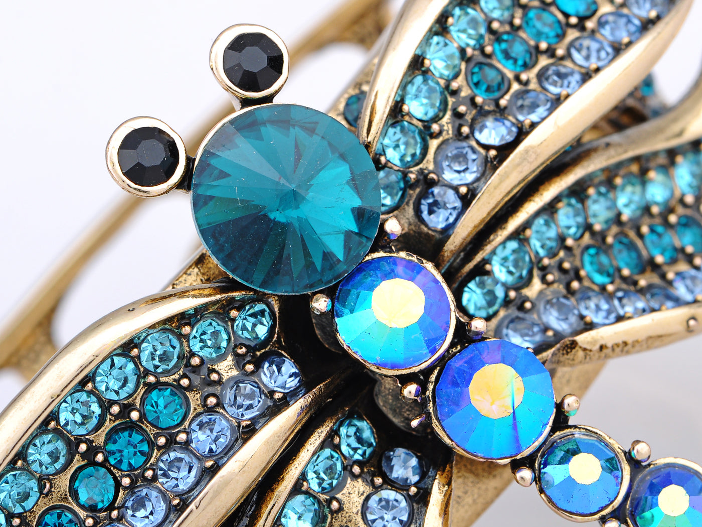 Electrifying Blue Zircon Dragonfly Over A Gold Cuff Bracelet
